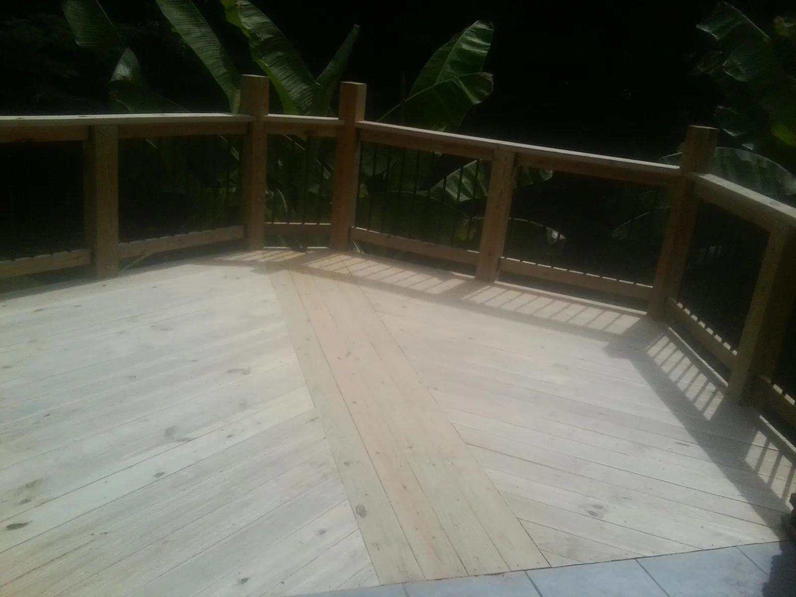 New wood deck and railing built off the back of a home in Taholah